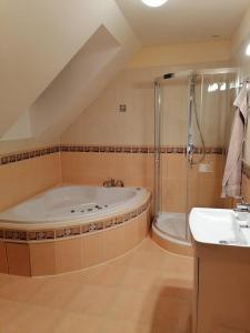 a large bathroom with a tub and a sink at Vila Tatranka in Stará Lesná +15 photos