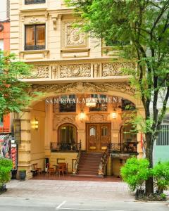 a large building with stairs and tables in front of it at Sam Royal Apartment in Ho Chi Minh City