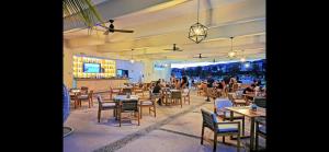a restaurant with tables and chairs and people in the background at Casamarmareazul in Playa del Carmen