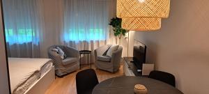 a small room with a bed and a table and chairs at Appartamento La Torretta in Locarno