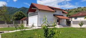 a white house with a red roof at Meem in Konjic