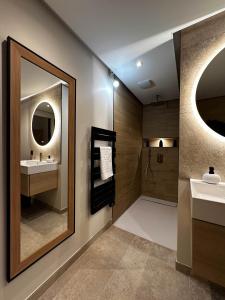 a bathroom with two sinks and a mirror at Loft Cocoon Spa in Nîmes +28 photos