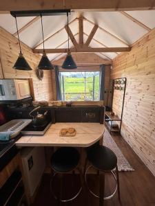a kitchen with a counter and stools in a room at Riverside cabin in Limerick +32 photos