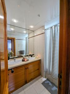 a bathroom with a sink and a large mirror at Apartment in Club Paraiso Ocean View, Wi-Fi in Playa Paraiso