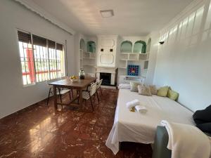 a bedroom with a large bed and a table at Casa Rural Alora Caminito del Rey in Alora +4 photos