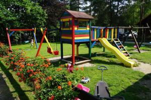 a park with a playground with slides and flowers at Ośrodek Azyl Mironice in Kłodawa