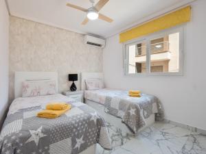 a bedroom with two beds and a window at Apolo beach front - sea view luxury apartment in Torrevieja