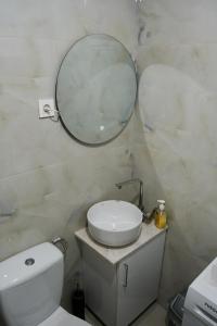 a bathroom with a sink and a mirror on the wall at Apartman Lili in Ohrid