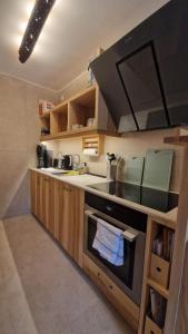 a kitchen with a sink and a stove top oven at Ferienwohnung BERGWELTEN in Oberaudorf