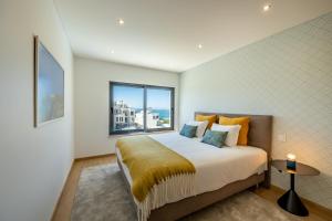 a bedroom with a bed and a large window at Silver Coast Beach Villa-Casa de Luxo com Piscina e Vista Mar in Lourinhã +180 photos