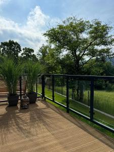 a wooden deck with a fence and some plants at Apartament Uzdrowiskowa I Prestige in Szczyrk