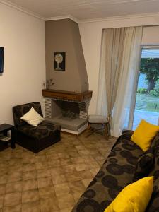 a living room with a couch and a fireplace at Casa Venti Perea in Perea