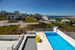 a villa with a swimming pool and a view of the ocean at Silver Coast Beach Villa-Casa de Luxo com Piscina e Vista Mar in Lourinhã