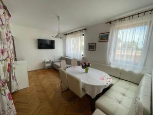 a living room with a table and a couch at Apartments Cavar in Rab