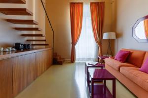 a living room with a couch and a staircase at Prêtáloger Verdi 18 in Naples