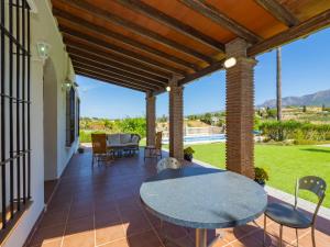 a patio with a table and chairs on it at Cubo's Finca Tallulah in Villafranco de Guadalhorce