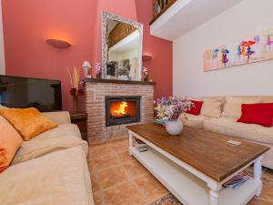 a living room with a couch and a fireplace at Cubo's Finca Tallulah in Villafranco de Guadalhorce