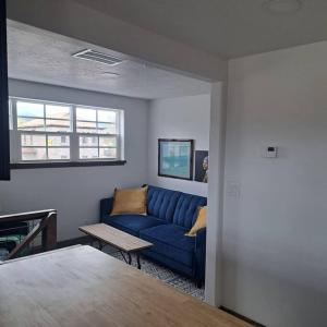 a living room with a blue couch and a table at Marysvale House by Bryce and Piute Trail in Marysvale