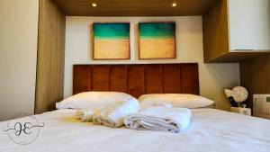 a bedroom with a bed with towels on it at Mana Beach 313C - Praia de Muro Alto em Porto de Galinhas in Ipojuca