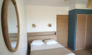 a bedroom with two beds and a mirror at MOTEL ASCOT - Hotel & Appartements in Cagnes-sur-Mer