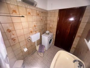 a bathroom with a toilet and a sink and a urinal at Alex house Thassos in Skala Sotiros