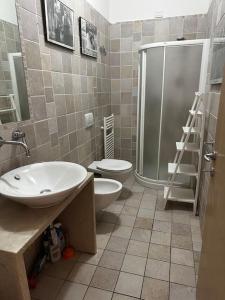 a bathroom with a shower and a sink and a toilet at Casa Norma Oasi di pace a un passo dal mare in Querceta +16 photos