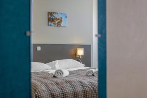 Postel nebo postele na pokoji v ubytování Corvin Hotel Budapest Corvin Wing