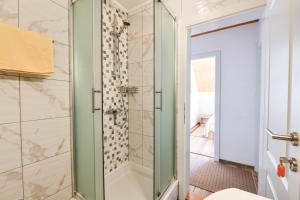a bathroom with a shower with a glass door at Apartment & Rooms Luketic in Rastovača +97 photos