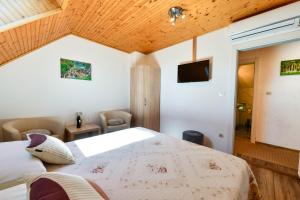 a bedroom with a large bed and a tv at Apartment & Rooms Luketic in Rastovača