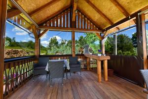 a wooden deck with a table and chairs at Apartment & Rooms Luketic in Rastovača