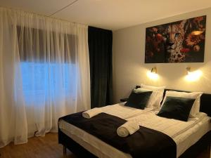 Hotell City Karlshamn tesisinde bir odada yatak veya yataklar
