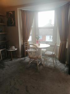 a dining room with a table and chairs and a window at BNB Retreat Broadstairs Kent in Kent