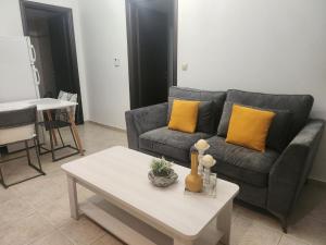 a living room with a couch and a coffee table at Angel Rooms in Yiofirákia