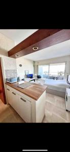 a kitchen and living room with a couch and a table at #101 MARINA RIVIERA BAY - Studio 30m2 avec terrasse vue Mer in Villeneuve-Loubet