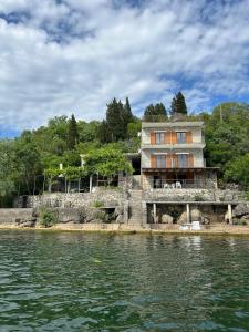 a house on an island in the water at Sunny Terraces in Cetinje