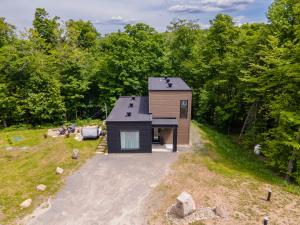 a tiny house in the middle of a yard at Chalet Listra peace & spa - 16 min to Tremblant in La Conception