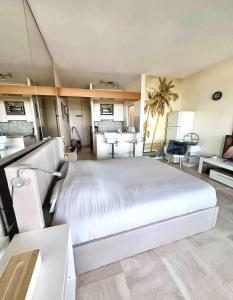 a large bedroom with a large white bed in it at #101 MARINA RIVIERA BAY - Studio 30m2 avec terrasse vue Mer in Villeneuve-Loubet +3 photos