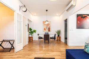 a living room with a table and chairs at Mestalla River Apartment in Valencia +39 photos
