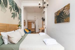 a bedroom with a large bed with white pillows at Mestalla River Apartment in Valencia