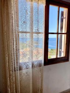 a window with a view of the ocean at Betsanis Stafylos Apartments in Stafylos