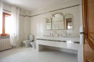 a white bathroom with a sink and a toilet at holiday House Na Te in Riccò del Golfo di Spezia +23 photos