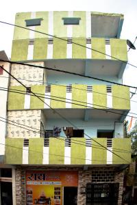 a building with green and white stripes on it at Rai Guest House in Ujjain