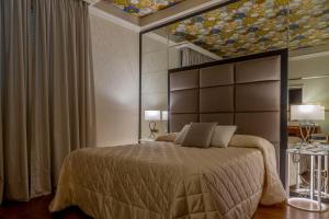 Postel nebo postele na pokoji v ubytování Boutique Hotel Puccini