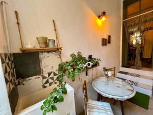 a table and chairs in a room with a table and a table and a window at Casa Cercana in Abarán