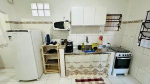 una piccola cucina con frigorifero e lavandino di Casa Jardim Colorado a Vila Velha