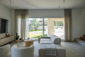 a living room with a couch and chairs and a tv at Villa Olea 2024 Heated Pool -Sauna -400 m beach in Kaštela