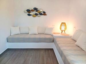 a living room with two couches and a lamp at Rhodes Soul Luxury Suites in Afantou