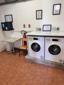 a laundry room with a washing machine and a table at Antibes Port - Terrasse - Parking - Piscine in Antibes