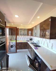 a kitchen with a sink and a washing machine at اقامة نور in Nador +28 photos