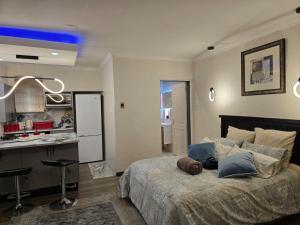 a bedroom with a bed with a teddy bear on it at Okoli's Place in Sandown